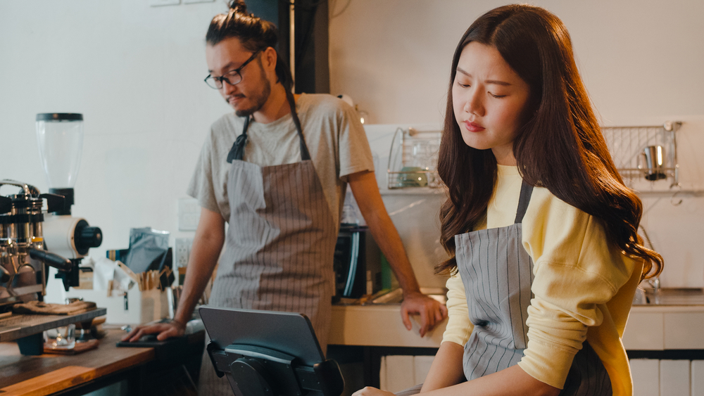 Young,Asia,Female,And,Male,Barista,Waiter,Overwhelmed,By,Finance