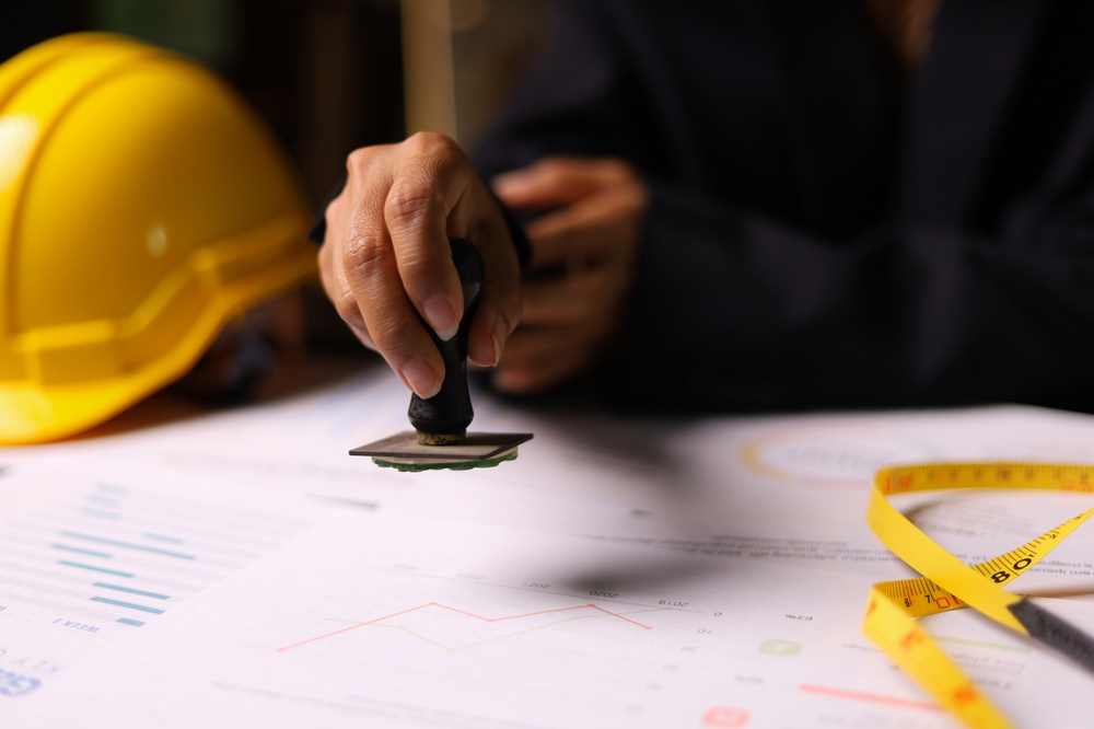 Close-up,Of,A,Construction,Supervision,Hand,Stamping,Document,In,The