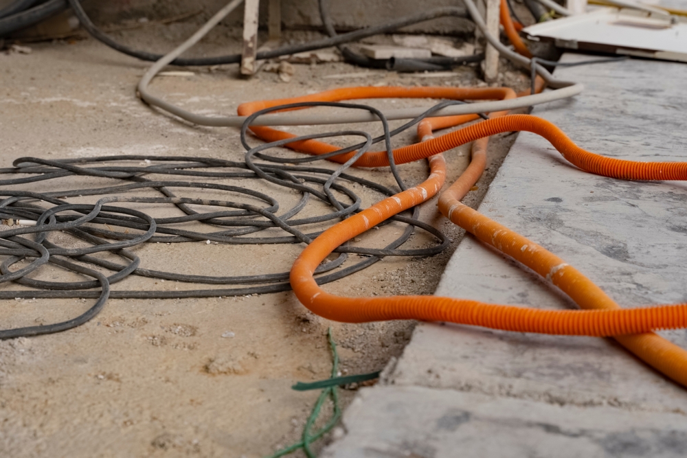 Close,Up,Orange,And,Black,Electric,Cables,Lie,On,The